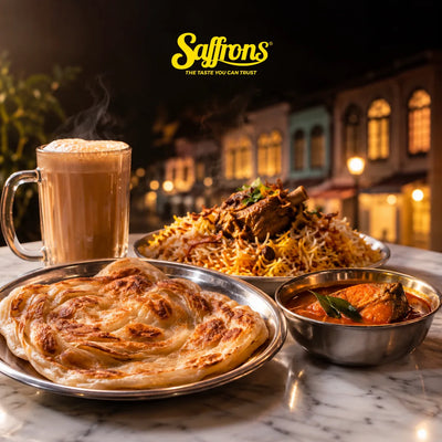 Katong Indian restaurant guide: roti prata with fish curry, mutton briyani and teh tarik on a marble table, with shophouses blurred behind