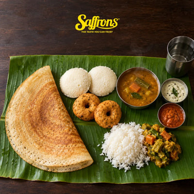 Thosai, idli, vadai, sambar and chutneys on a banana leaf, South Indian food Singapore